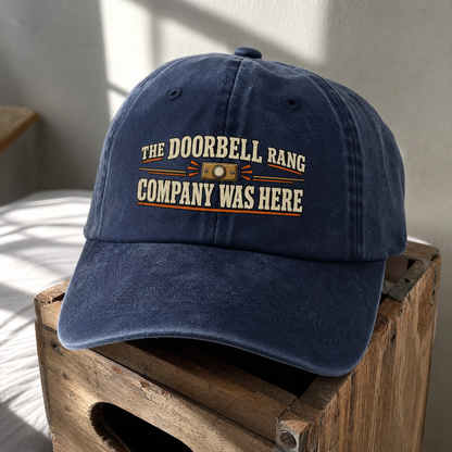 Navy vintage washed cap with printed The Doorbell Rang Company Was Here slogan front view