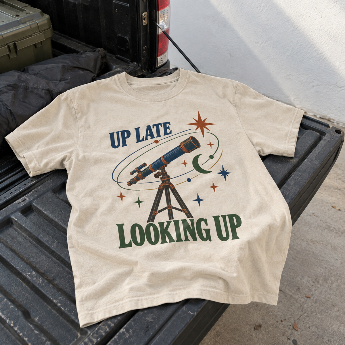 Vintage t-shirt with Up Late Looking Up telescope print on cream fabric, hero view