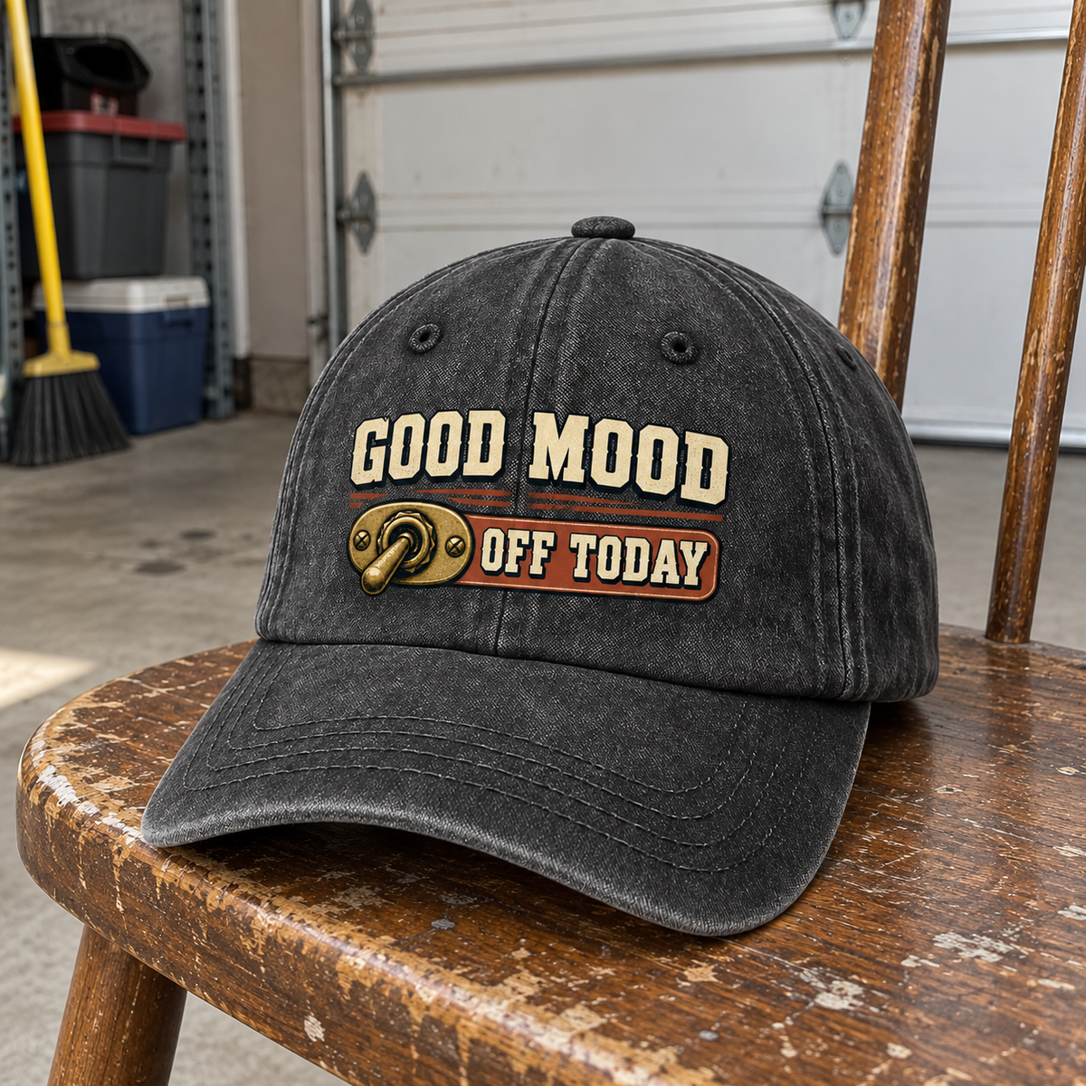Black vintage washed cap with printed Good Mood Off Today switch design on wooden chair