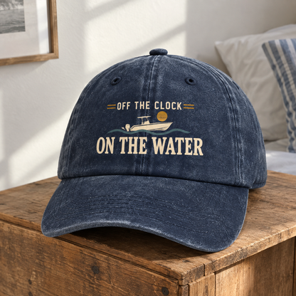 Navy vintage washed cap with printed Off The Clock On The Water slogan, front view