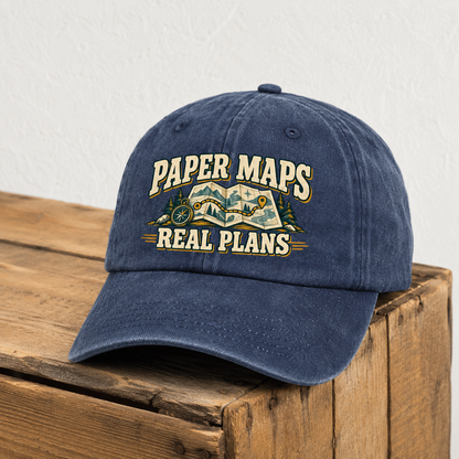 Navy vintage washed cap with printed Paper Maps Real Plans design on wooden surface