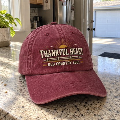 Burgundy vintage washed cap with printed Thankful Heart Old Country Soul design on countertop