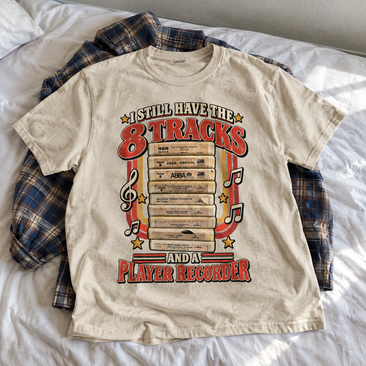 Cream vintage T-shirt with printed red 8 tracks, cassette tapes, music notes, and player recorder slogan laid flat.