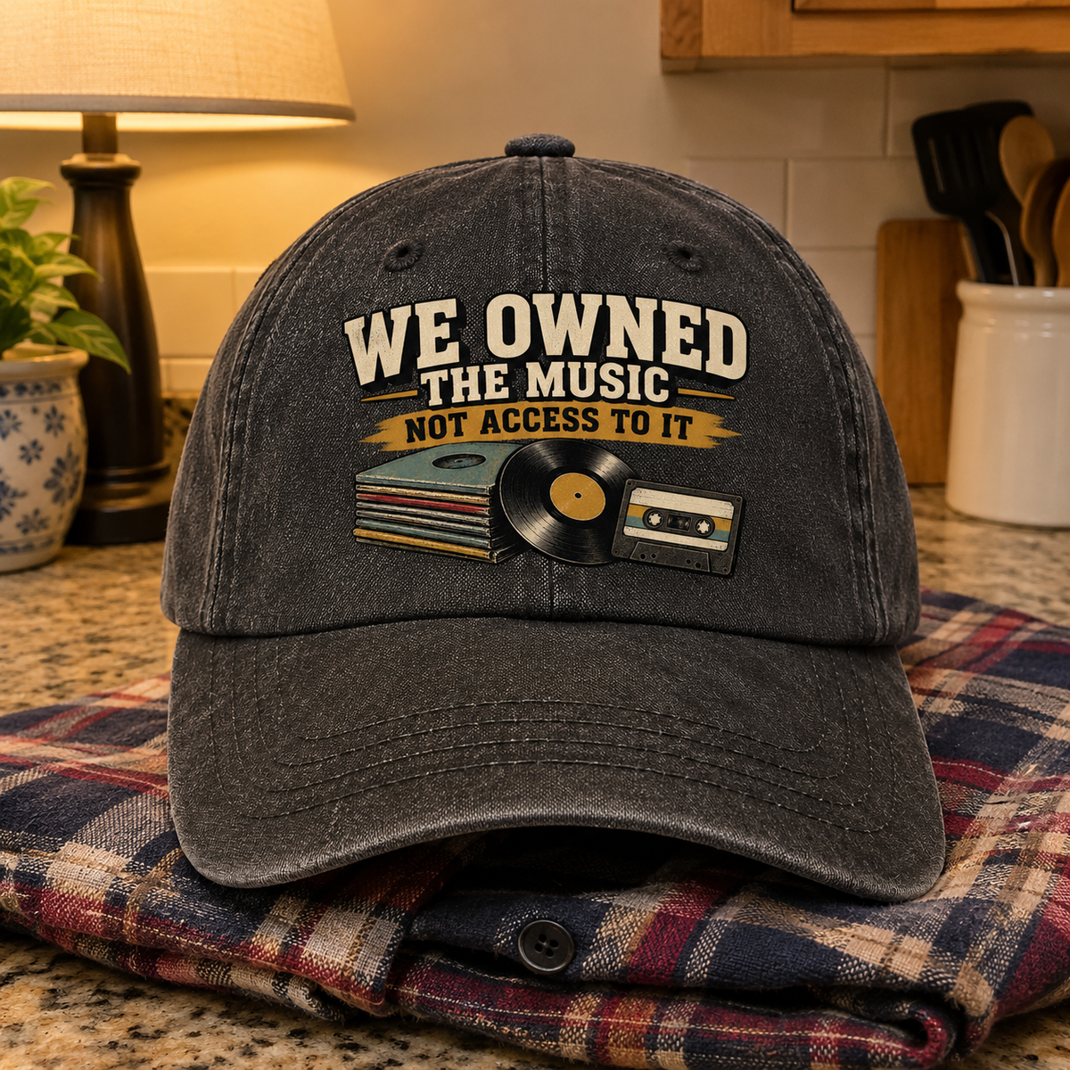 Black vintage washed cap with printed music slogan, vinyl record, cassette, and albums, front view.