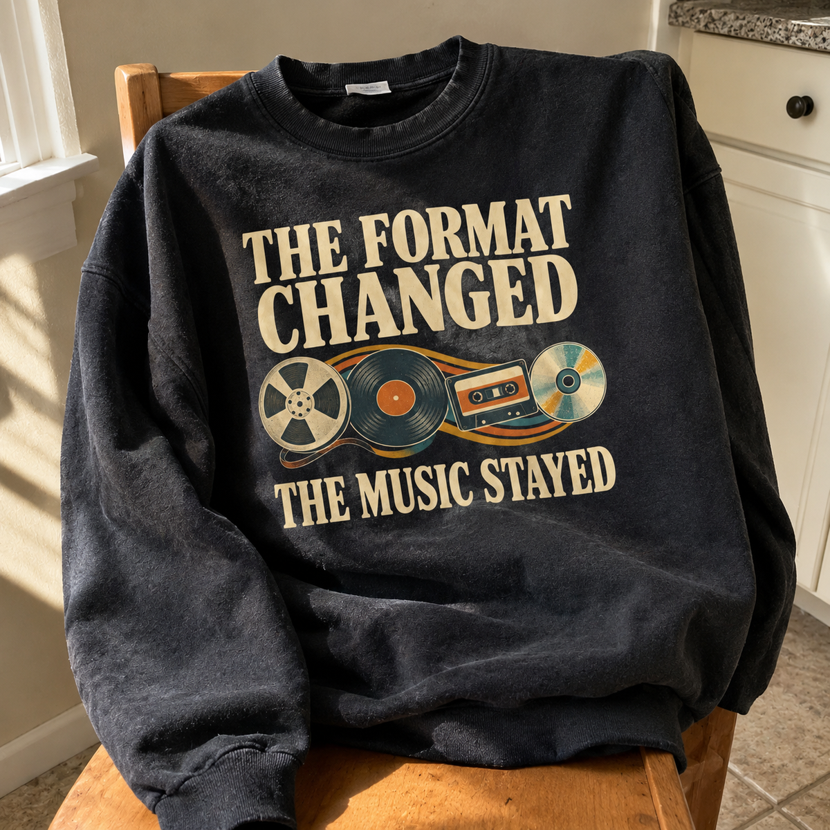Black vintage sweatshirt with printed music design and “The Format Changed The Music Stayed” slogan