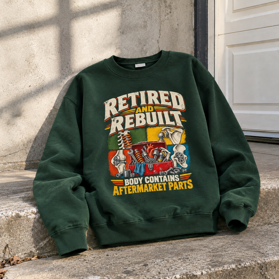 Dark green vintage sweatshirt with printed Retired And Rebuilt aftermarket parts slogan and colorful automotive