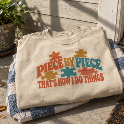 Vintage t-shirt with colorful printed puzzle pieces and Piece By Piece slogan, hero view