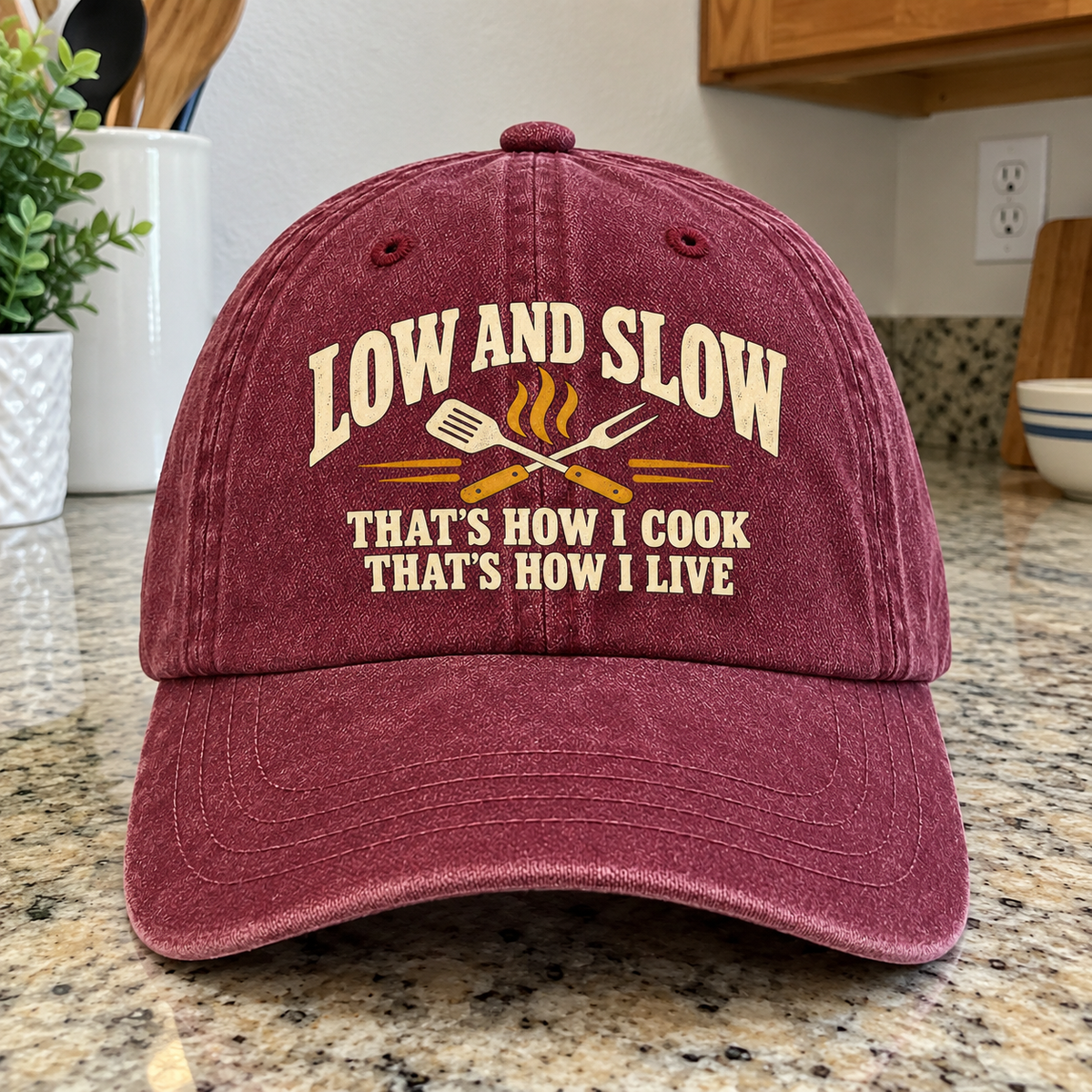 Burgundy vintage washed cap with printed Low And Slow cooking slogan and crossed utensils, front view