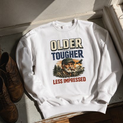 White vintage sweatshirt printed with Older Tougher Less Impressed and rugged outdoorsman design, hero view