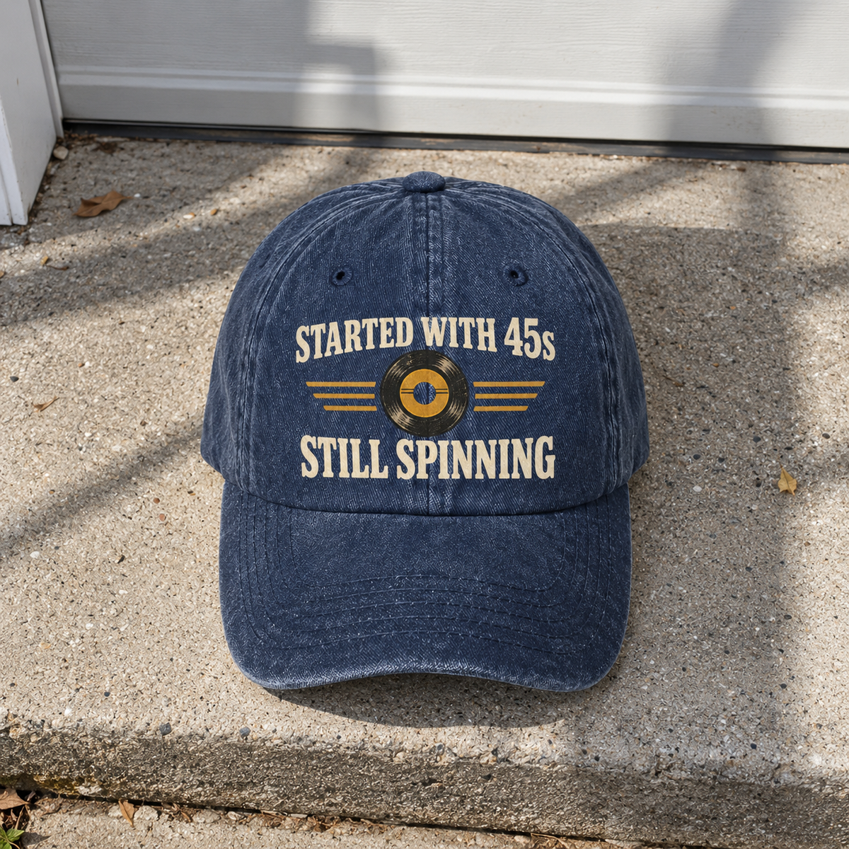 Navy vintage washed cap with printed Started With 45s Still Spinning slogan, front view