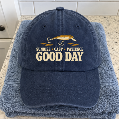Navy vintage washed cap with printed “Sunrise • Cast • Patience. Good Day” fishing design