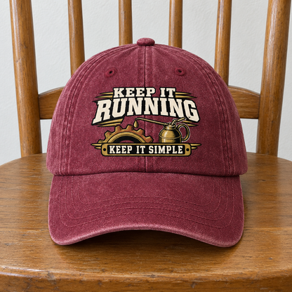 Burgundy vintage washed cap with printed “Keep It Running. Keep It Simple” design, front view