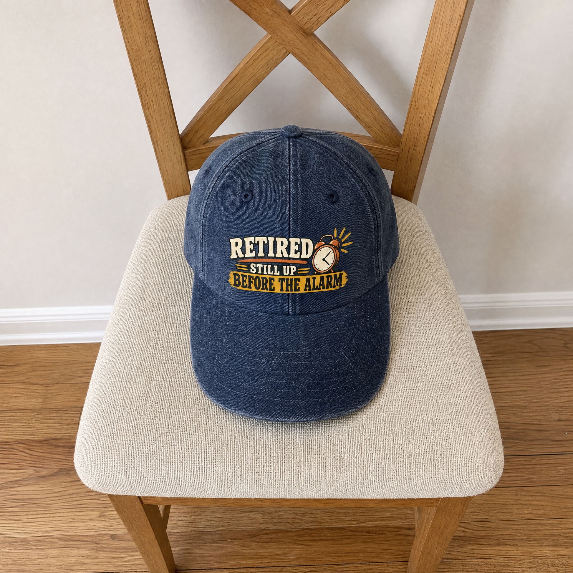 Blue vintage washed cap with printed Retired Still Up Before The Alarm slogan, front view.