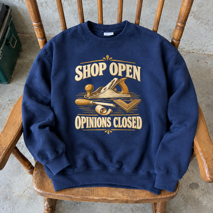 Navy vintage sweatshirt with printed Shop Open Opinions Closed slogan and woodworking tools, hero view