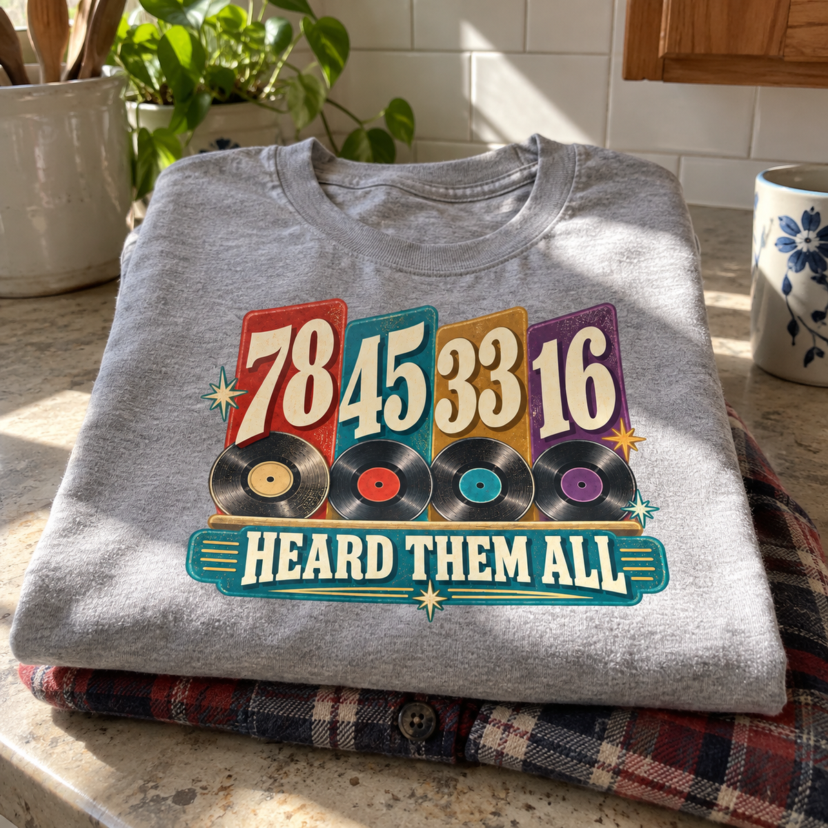 Folded gray vintage t-shirt with printed 78 45 33 16, records, and Heard Them All.