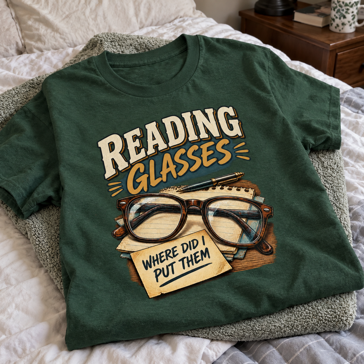 Dark green vintage t-shirt on bed with printed Reading Glasses Where Did I Put Them.