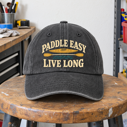 Vintage washed cap with printed Paddle Easy Live Long kayak design, front hero view