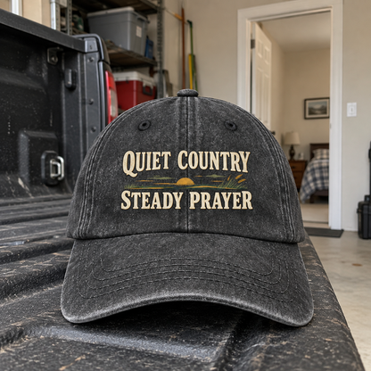 Charcoal vintage washed cap with printed Quiet Country Steady Prayer slogan on truck bed