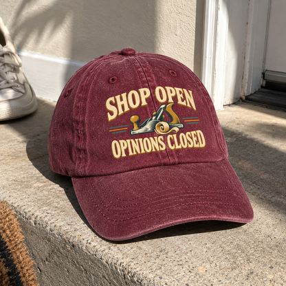 Burgundy vintage washed cap with printed Shop Open Opinions Closed slogan and hand plane graphic