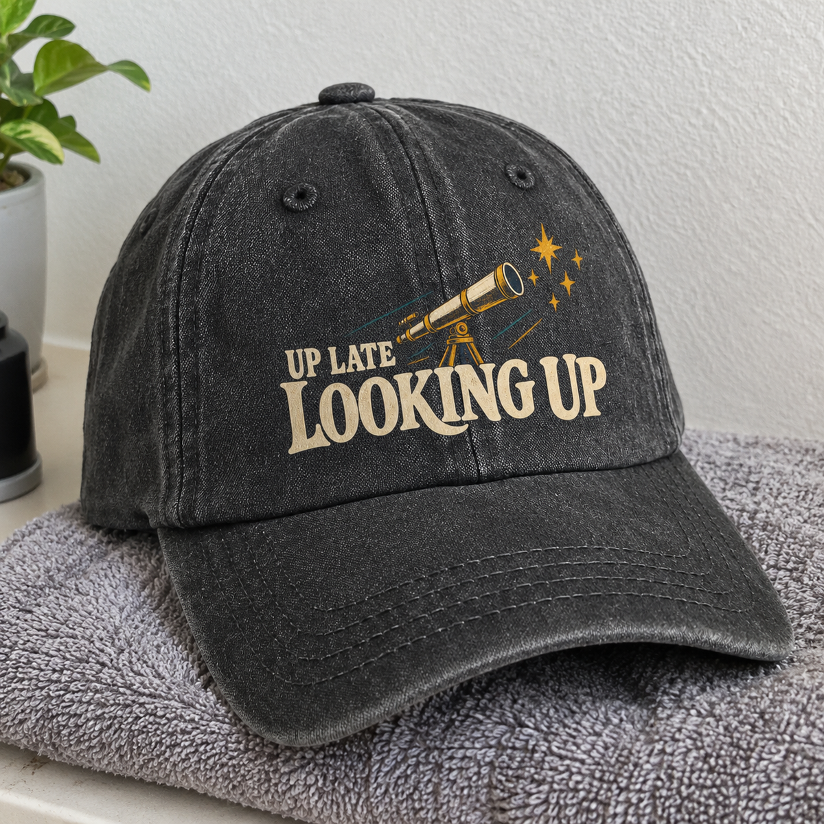 Black vintage washed cap with printed Up Late Looking Up telescope design, hero view