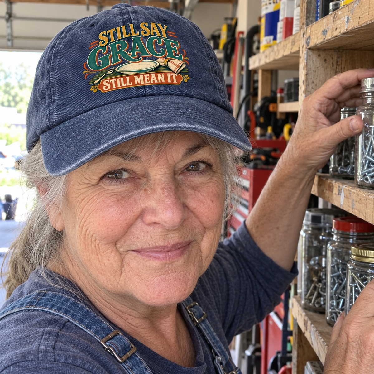 Senior woman wearing navy vintage washed cap printed Still Say Grace Still Mean It