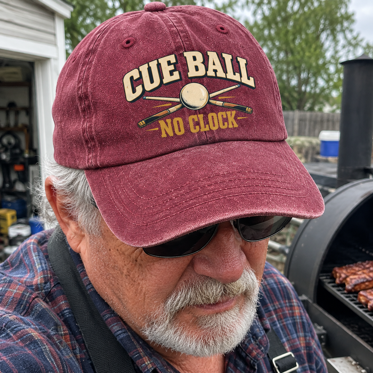 Maroon washed cap with printed Cue Ball No Clock design, worn by senior at barbecue.