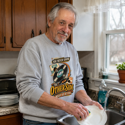 Senior man wearing gray vintage sweatshirt with printed You Never Know design in kitchen