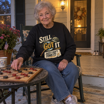 Senior woman playing checkers wears vintage sweatshirt printed Still Got It Just Can't Find It