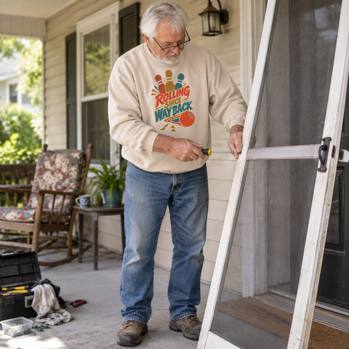 Cream vintage sweatshirt with printed Bowling Since Way Back design worn by senior man outdoors