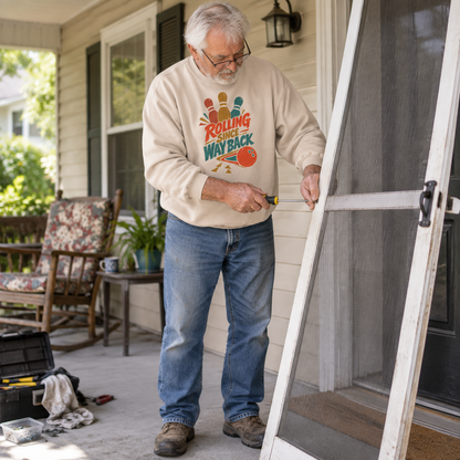 Cream vintage sweatshirt with printed Bowling Since Way Back design worn by senior man outdoors