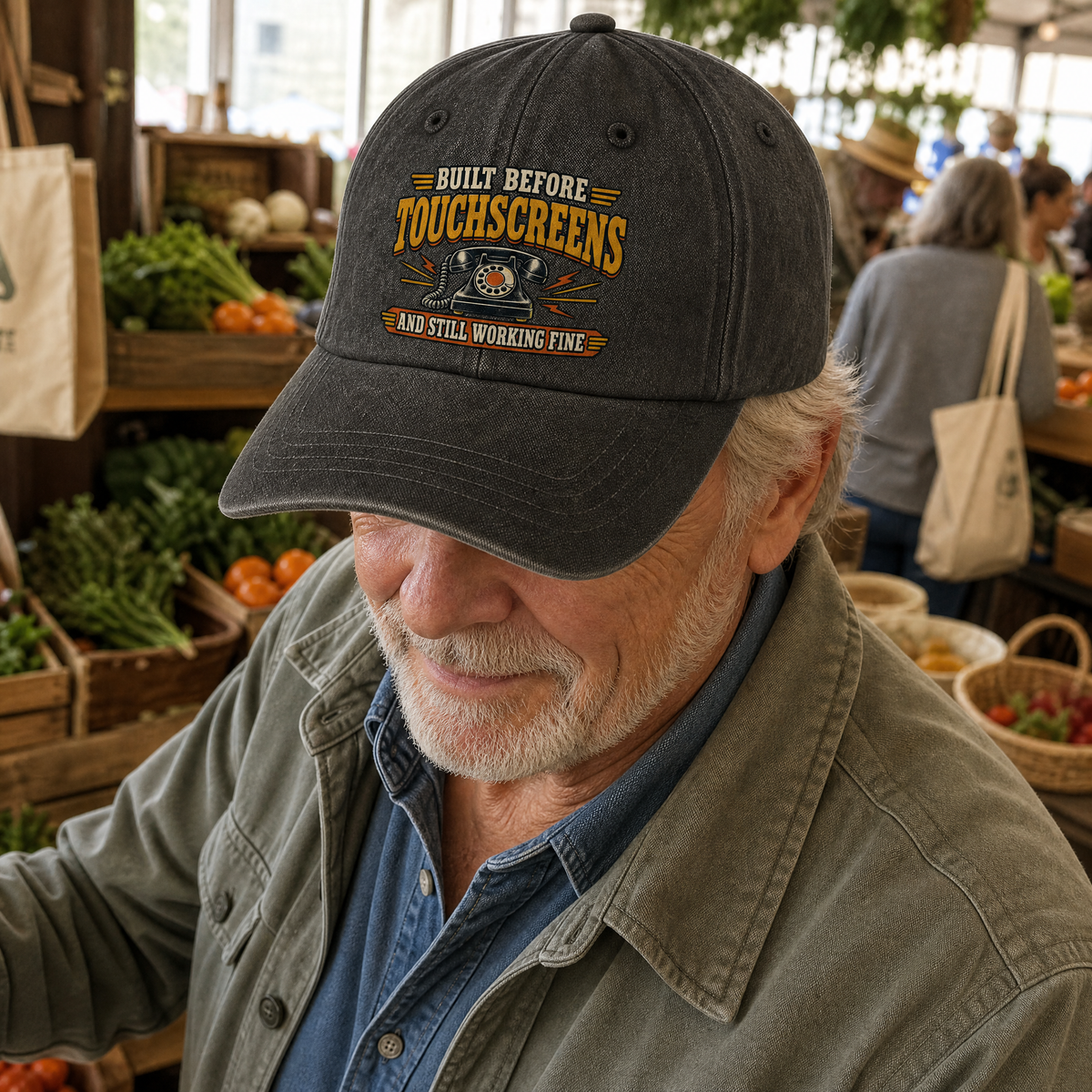Senior man wearing black vintage washed cap with printed touchscreen slogan at market.