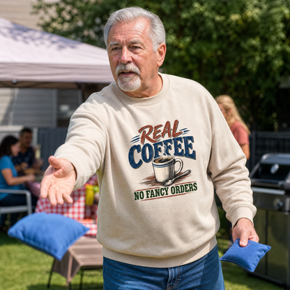 Senior man wearing beige vintage sweatshirt with printed Real Coffee. No Fancy Orders design.