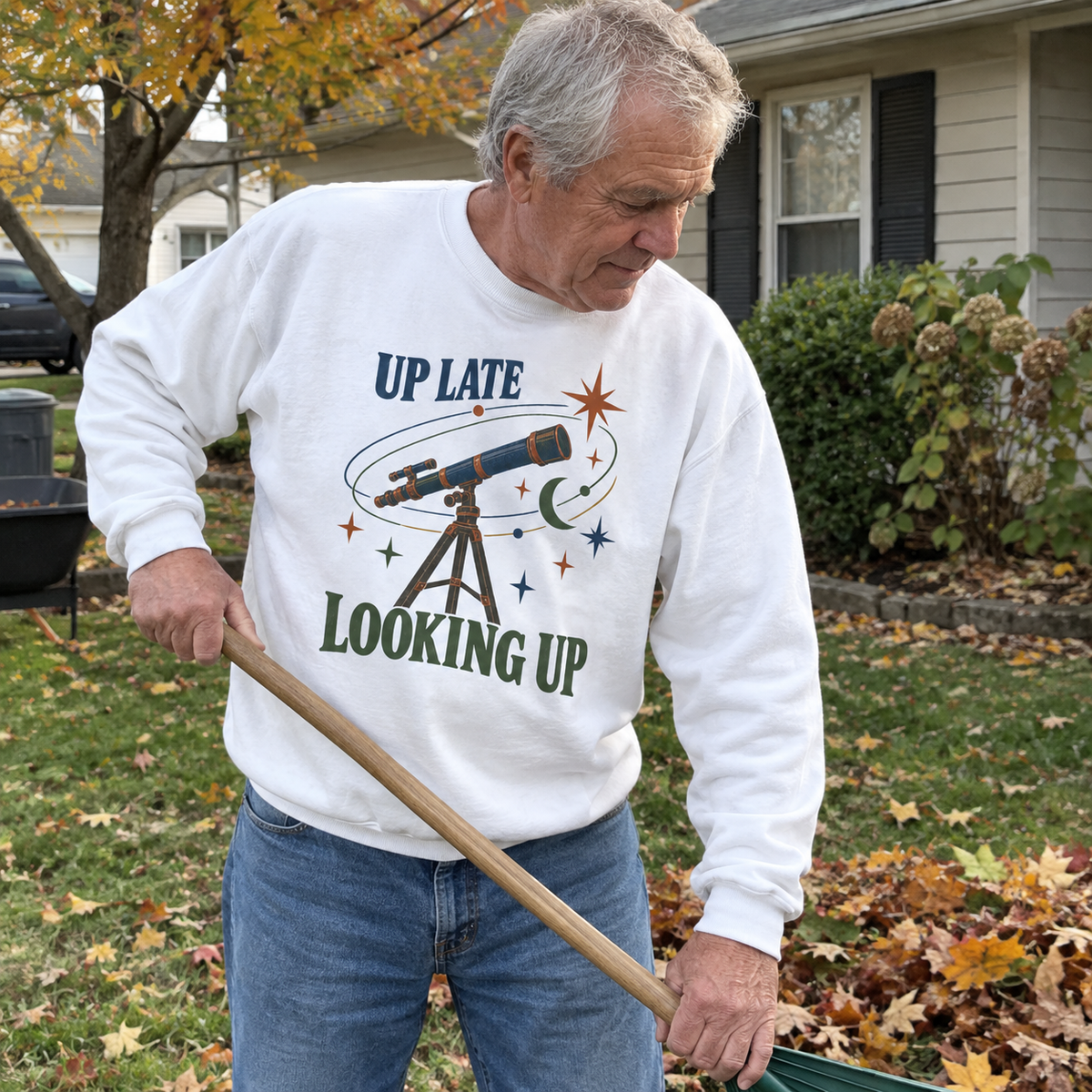 White vintage sweatshirt with printed Up Late Looking Up design worn by senior man outdoors