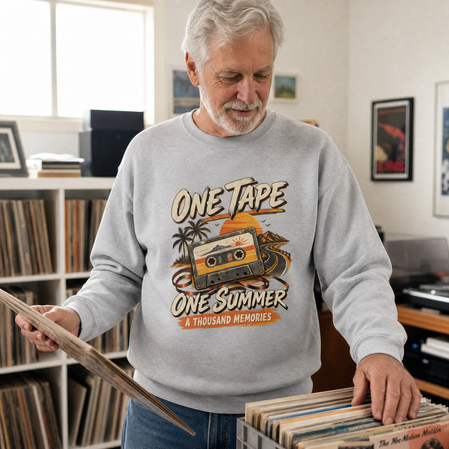 Gray vintage sweatshirt with printed One Tape One Summer design worn by senior man indoors.