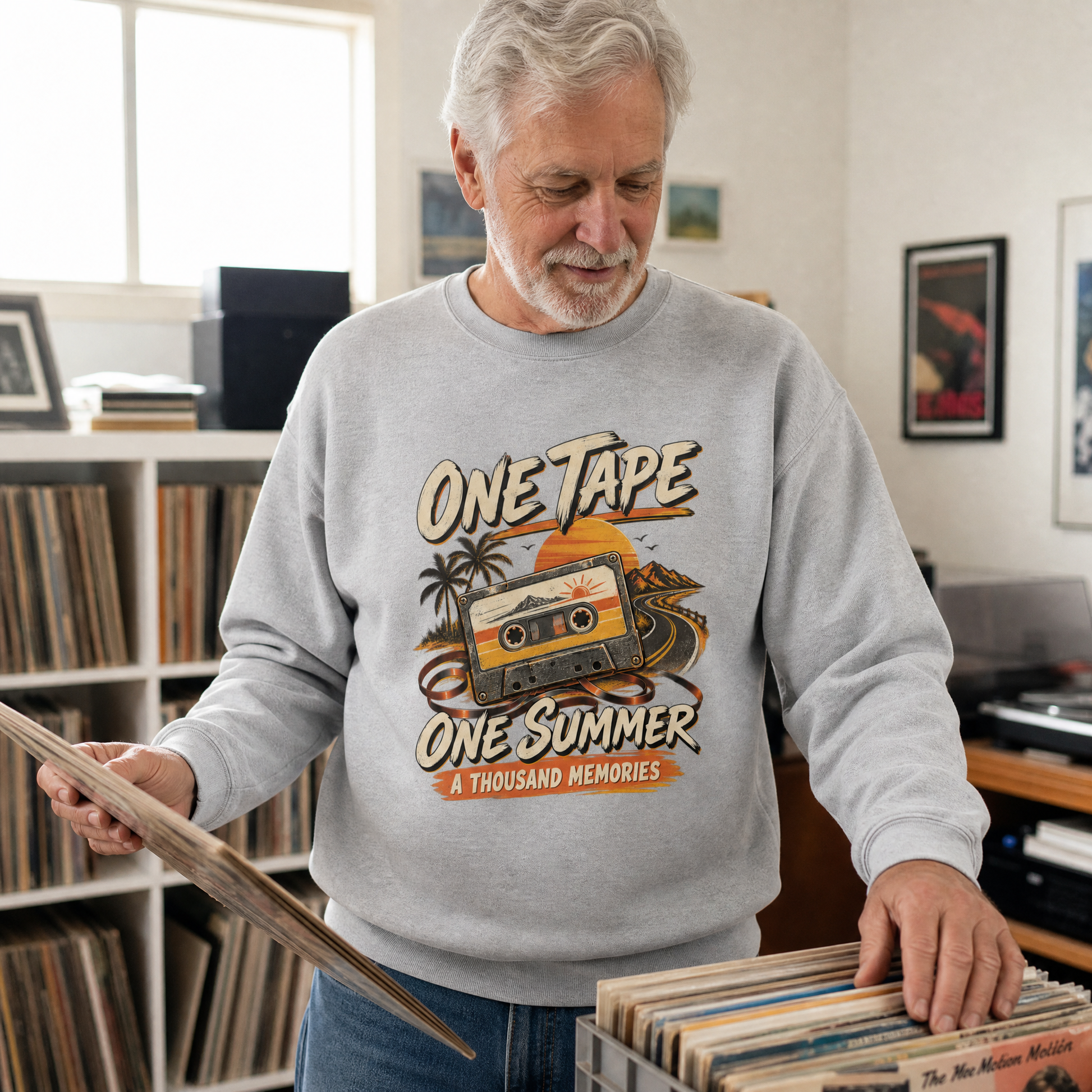 Gray vintage sweatshirt with printed One Tape One Summer design worn by senior man indoors.