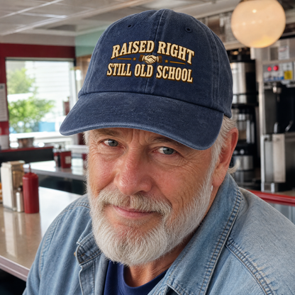 Navy vintage washed cap with printed Raised Right Still Old School slogan on older man