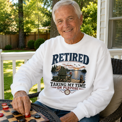 Senior man wearing white vintage sweatshirt with printed RETIRED Taking My Time design outdoors
