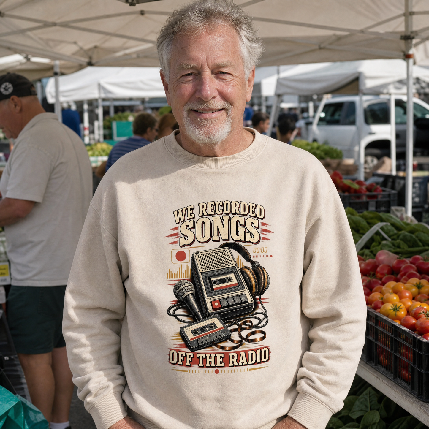 Senior man wears beige vintage sweatshirt with printed We Recorded Songs Off The Radio design