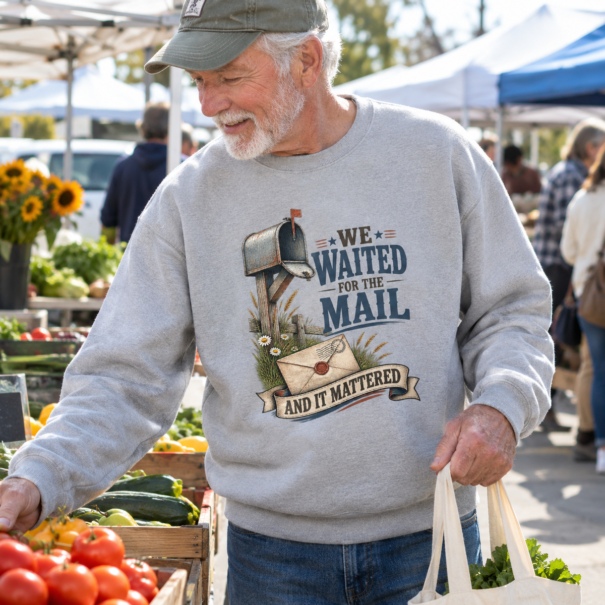 Senior man wearing gray vintage sweatshirt with printed mail slogan at farmers market