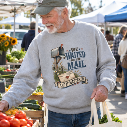 Senior man wearing gray vintage sweatshirt with printed mail slogan at farmers market