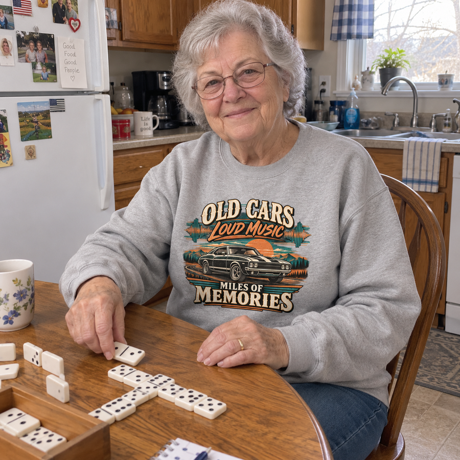 Senior woman playing dominoes in gray vintage sweatshirt with printed car and slogan