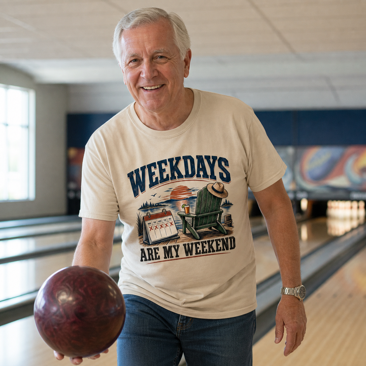 Senior man wearing a beige vintage t-shirt printed with “Weekdays Are My Weekend” at a bowling alley