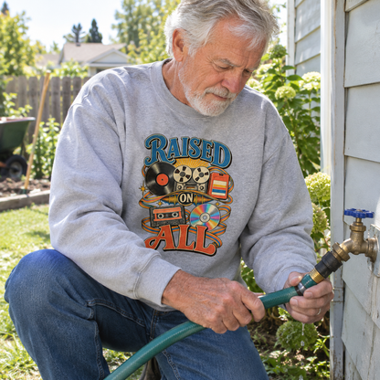 Senior wearing vintage sweatshirt with Raised On All printed design