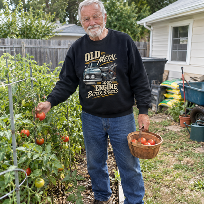 Senior man wearing black vintage sweatshirt with Old Metal Good Engine Better Stories print, gardening with tomatoes.