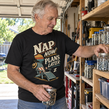 Senior man wearing black vintage t-shirt with printed Nap Now Plans Later design in garage
