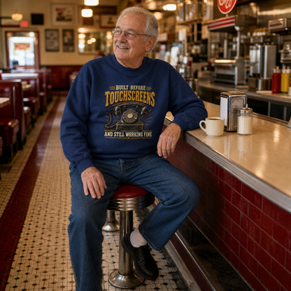 Navy vintage sweatshirt with printed slogan worn by senior man in diner.