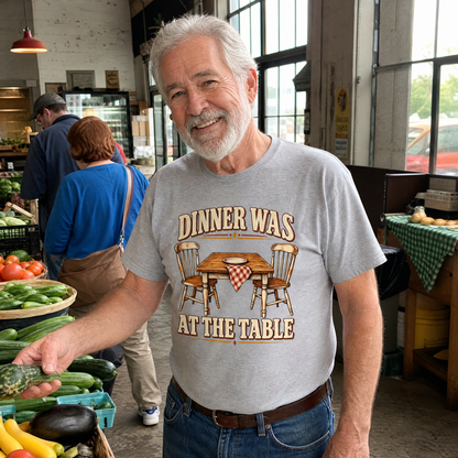 Senior man wearing gray vintage t-shirt with printed Dinner Was At The Table slogan