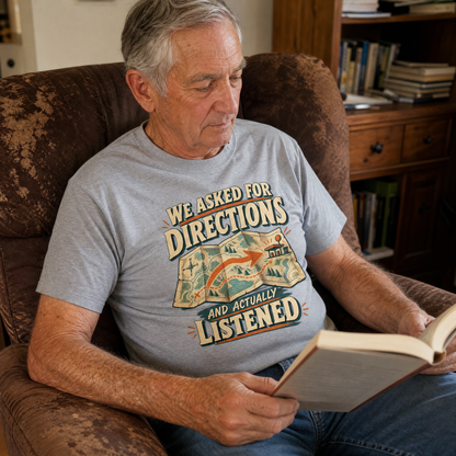 Senior man wearing a gray vintage t-shirt with printed directions slogan, reading indoors.