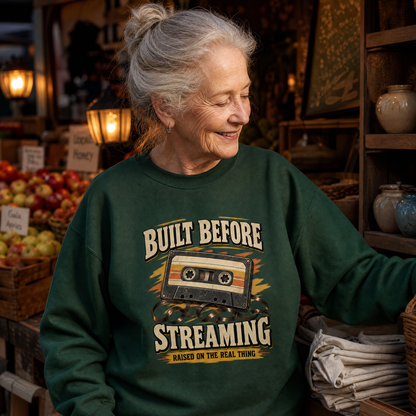Senior woman wearing green vintage sweatshirt with printed Built Before Streaming slogan in shop
