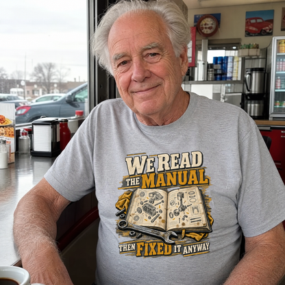Senior man wearing gray vintage t-shirt with printed manual repair slogan, seated in diner.
